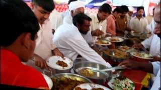 Men grabbing food at a wedding reception in Pakistan [upl. by Ebaj]